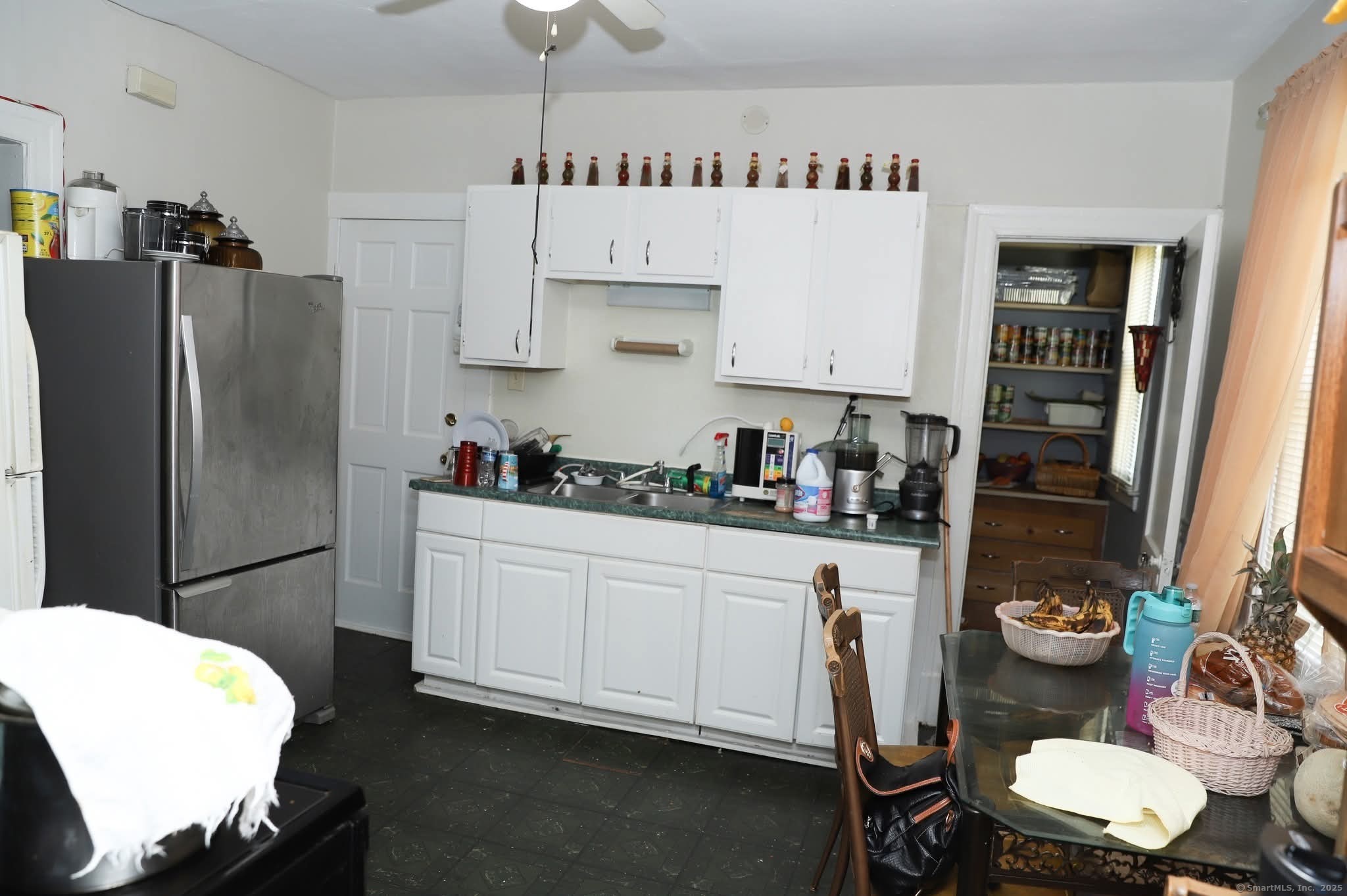 11 Pershing Street Hartford, CT 06112 - Photo 8 of 37 a kitchen with stainless steel appliances a refrigerator sink and white cabinets