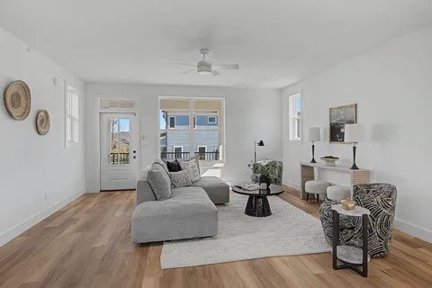 a living room with furniture and wooden floor