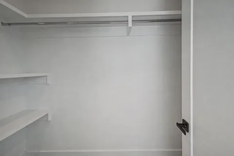 a bathroom with a sink vanity and a shower