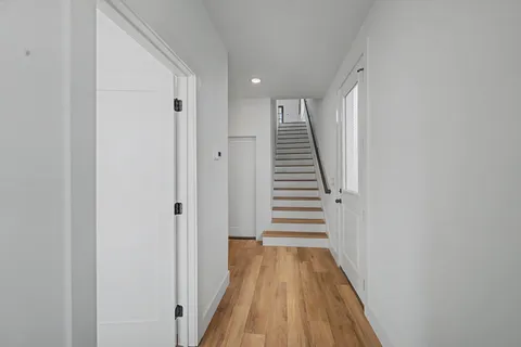 a kitchen with stainless steel appliances granite countertop a kitchen island hardwood floor sink stove and granite counter top