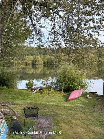 a view of a yard with wooden fence