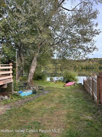 a view of a chairs and table in the backyard
