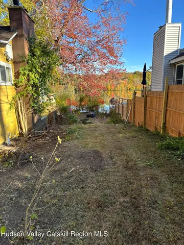 a view of a house with backyard and chairs
