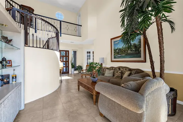 a kitchen with stainless steel appliances granite countertop a sink a counter space and a view of living room