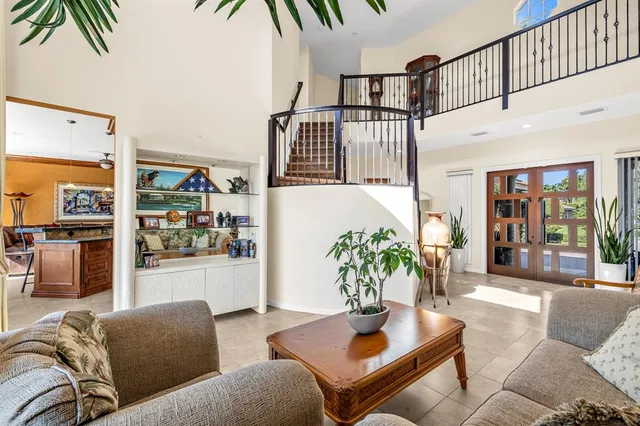 a dining room with furniture and a large window