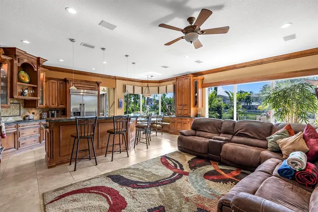 a view of a dining room with furniture a chandelier and wooden floor