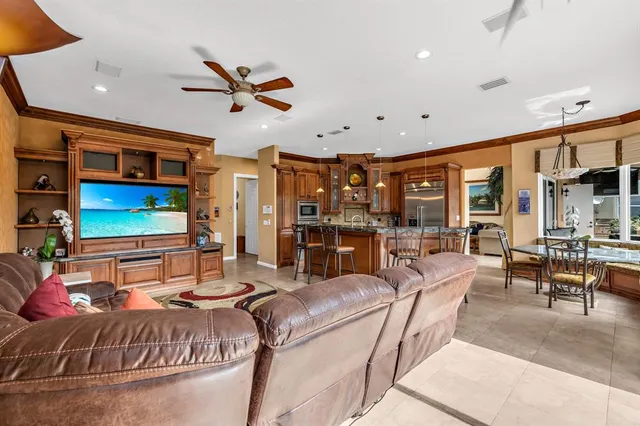 a view of a patio with table and chairs potted plants and palm tree