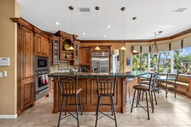 a view of a swimming pool with chairs and table in a patio