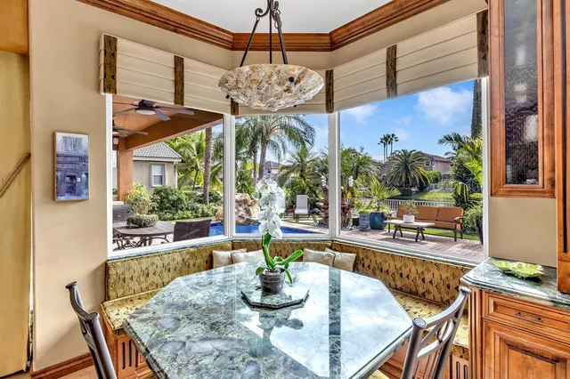 a view of a patio with table and chairs and potted plants