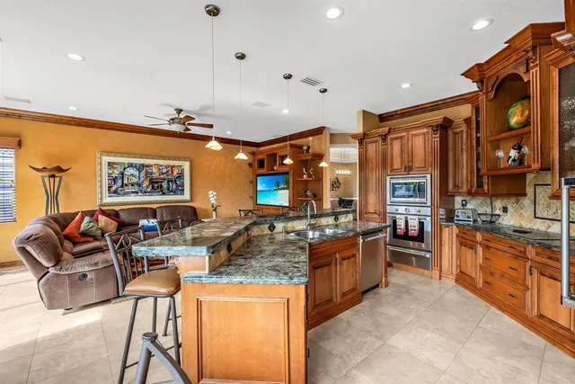 a kitchen with a stove a microwave and potted plant