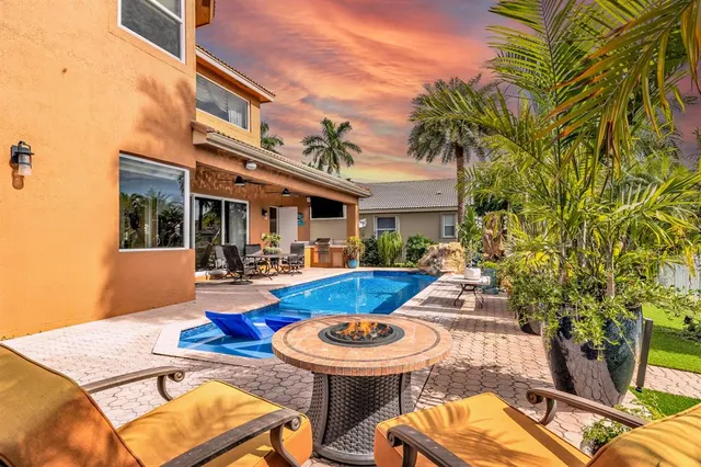 a view of a patio with swimming pool table and chairs