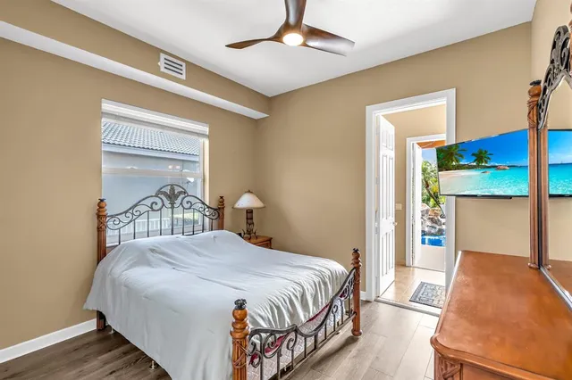 a bedroom with a bed and a chandelier