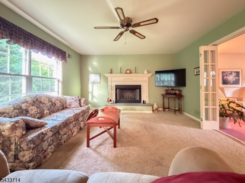 29 Lark Lane Oak Ridge, NJ 07438 - Photo 9 of 26 a living room with furniture fireplace and a window