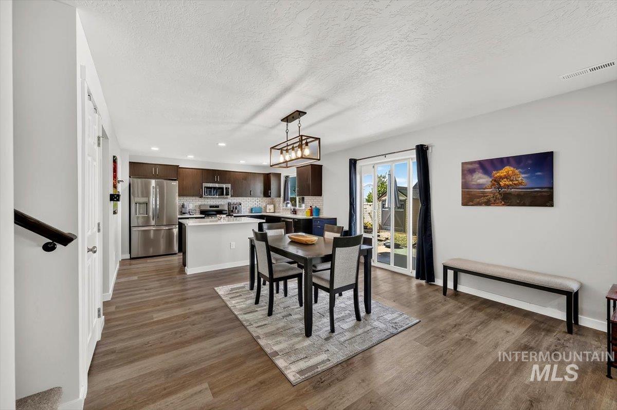 8575 South Foraker Way Kuna, ID 83634 - Photo 10 of 43 Spacious dining area with sliding door to backyard