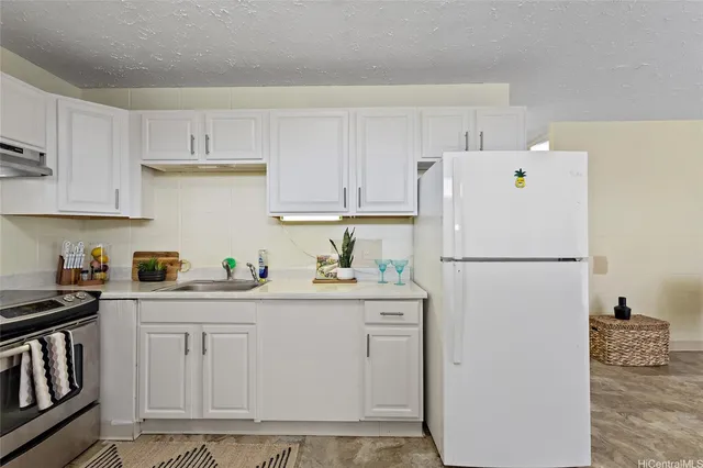 a white refrigerator freezer sitting in a kitchen