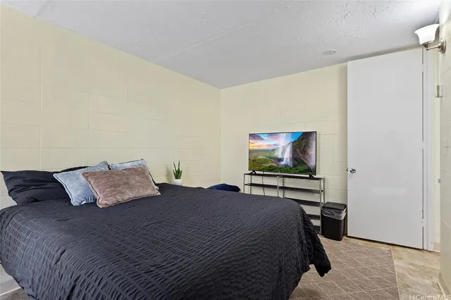 a bedroom with a bed and couch