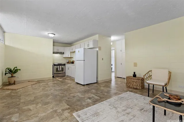 a view of kitchen with refrigerator and dining table