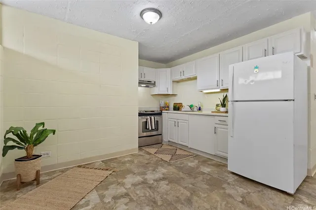 a kitchen with white cabinets and white appliances