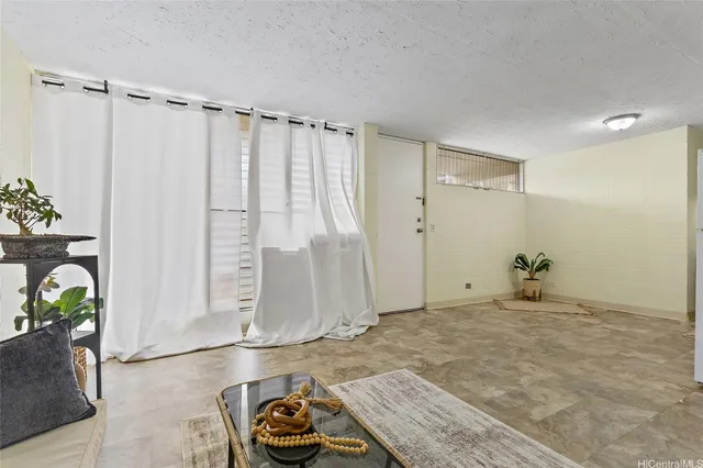 a view of a livingroom with furniture and floor to ceiling window