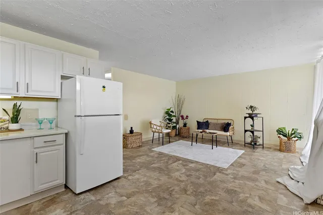 a view of kitchen with furniture and refrigerator