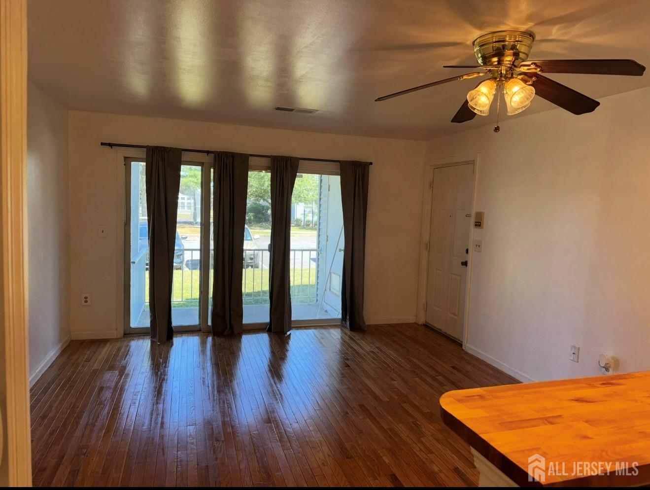 314 Edpas Road New Brunswick, NJ 08901 - Photo 2 of 8 wooden floor in an empty room with a window