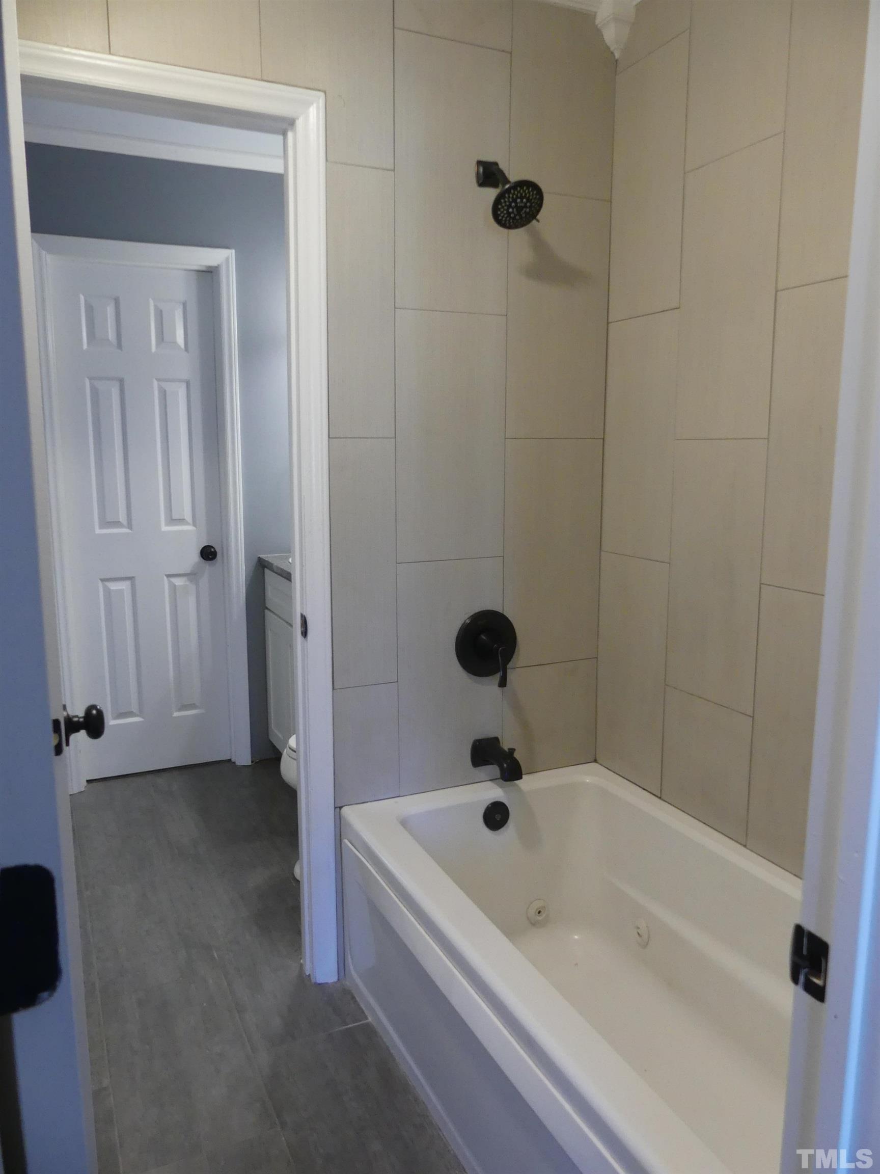 6520 English Oaks Drive Raleigh, NC 27615 - Photo 13 of 21 a bathroom with a tub and shower