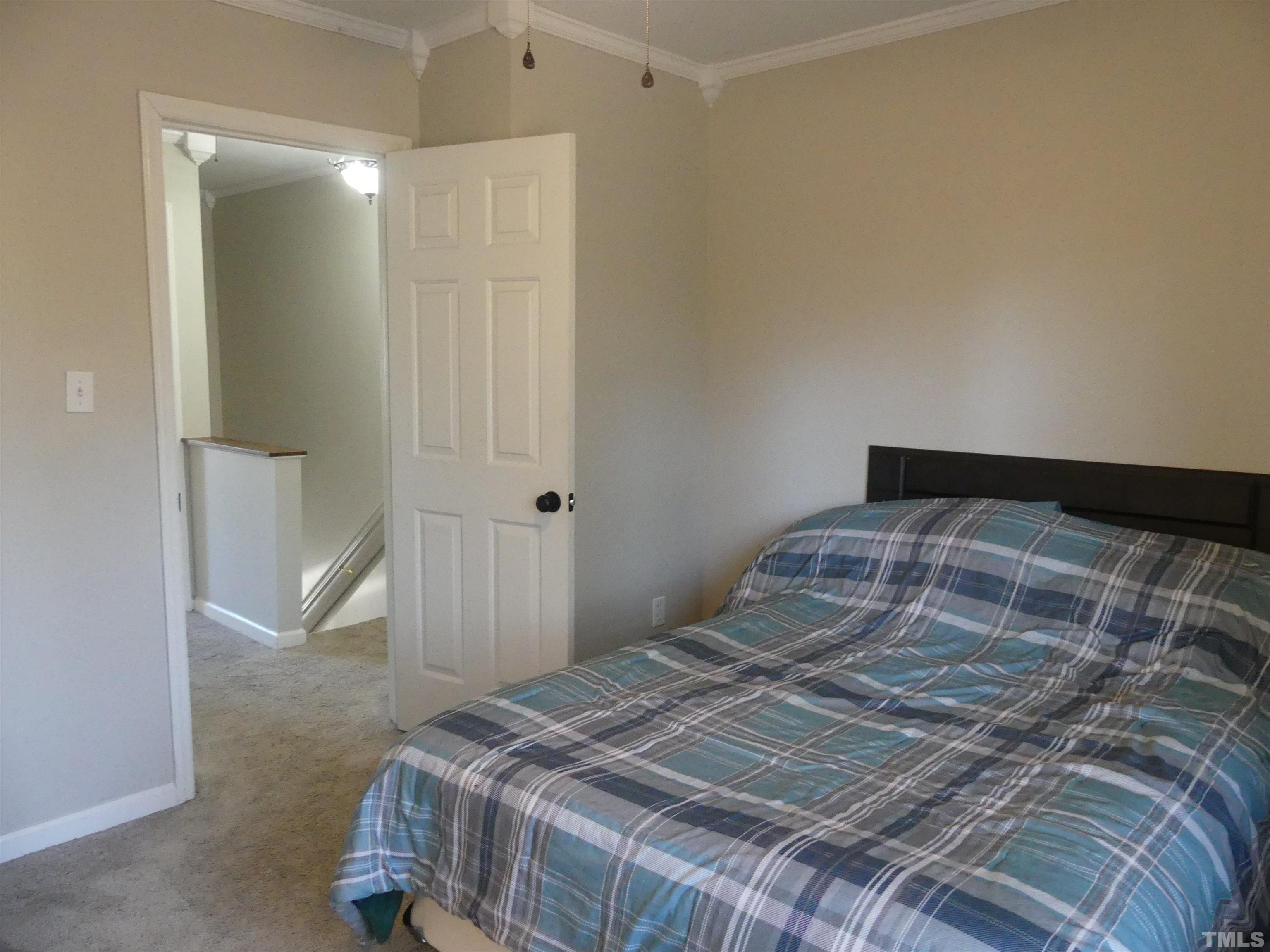 6520 English Oaks Drive Raleigh, NC 27615 - Photo 14 of 21 a bedroom with a bed and a shower