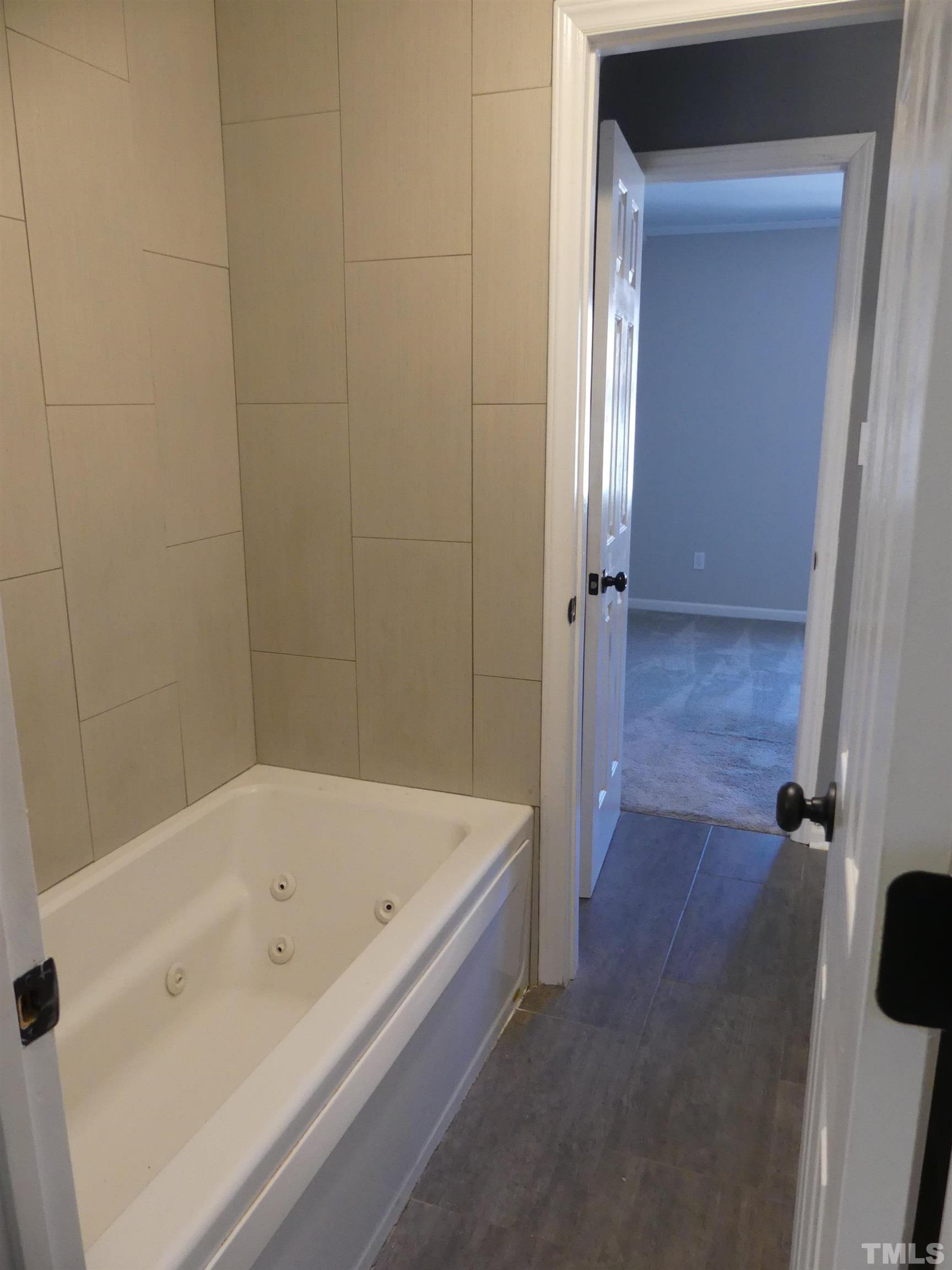 6520 English Oaks Drive Raleigh, NC 27615 - Photo 17 of 21 a bathroom with a bathtub
