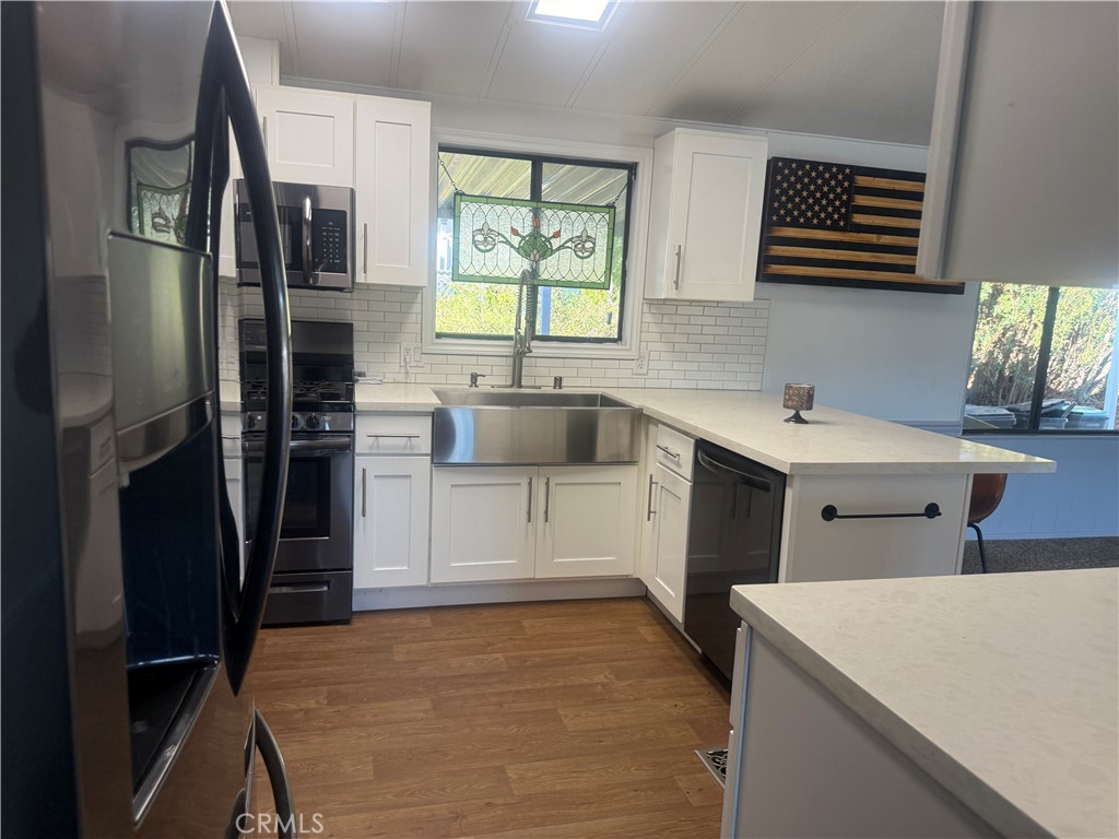 15181 Van Buren, Unit 256 Riverside, CA 92504 - Photo 11 of 34 a kitchen that has a sink a stove and a refrigerator
