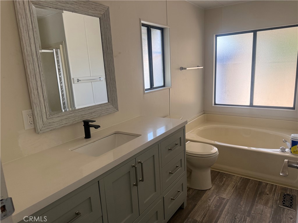15181 Van Buren, Unit 256 Riverside, CA 92504 - Photo 18 of 34 a bathroom with a sink a toilet and a mirror