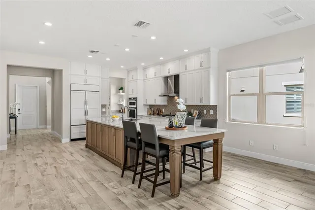 a view of a swimming pool with lawn chairs under an umbrella