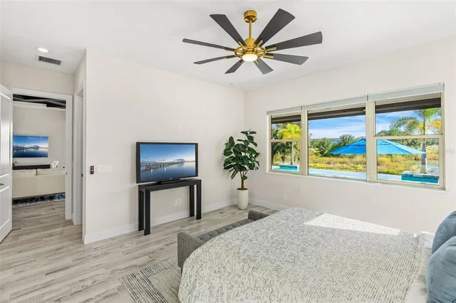 an empty room with window and wooden floor