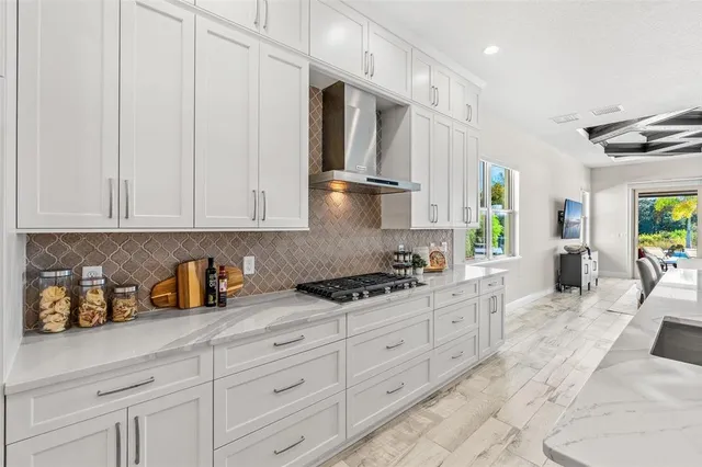 a living room with furniture a flat screen tv and a floor to ceiling window