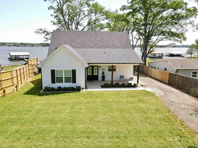 a view of a house with swimming pool and a yard