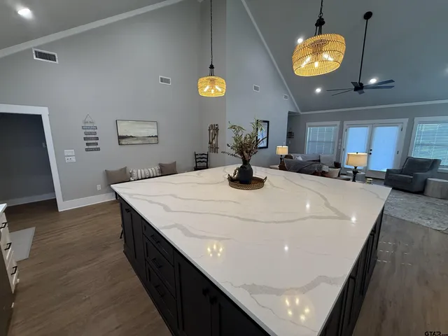 a bedroom with a bed and a chandelier