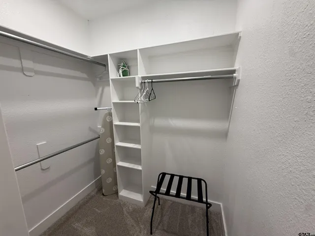 a bathroom with a sink a toilet a mirror and shower