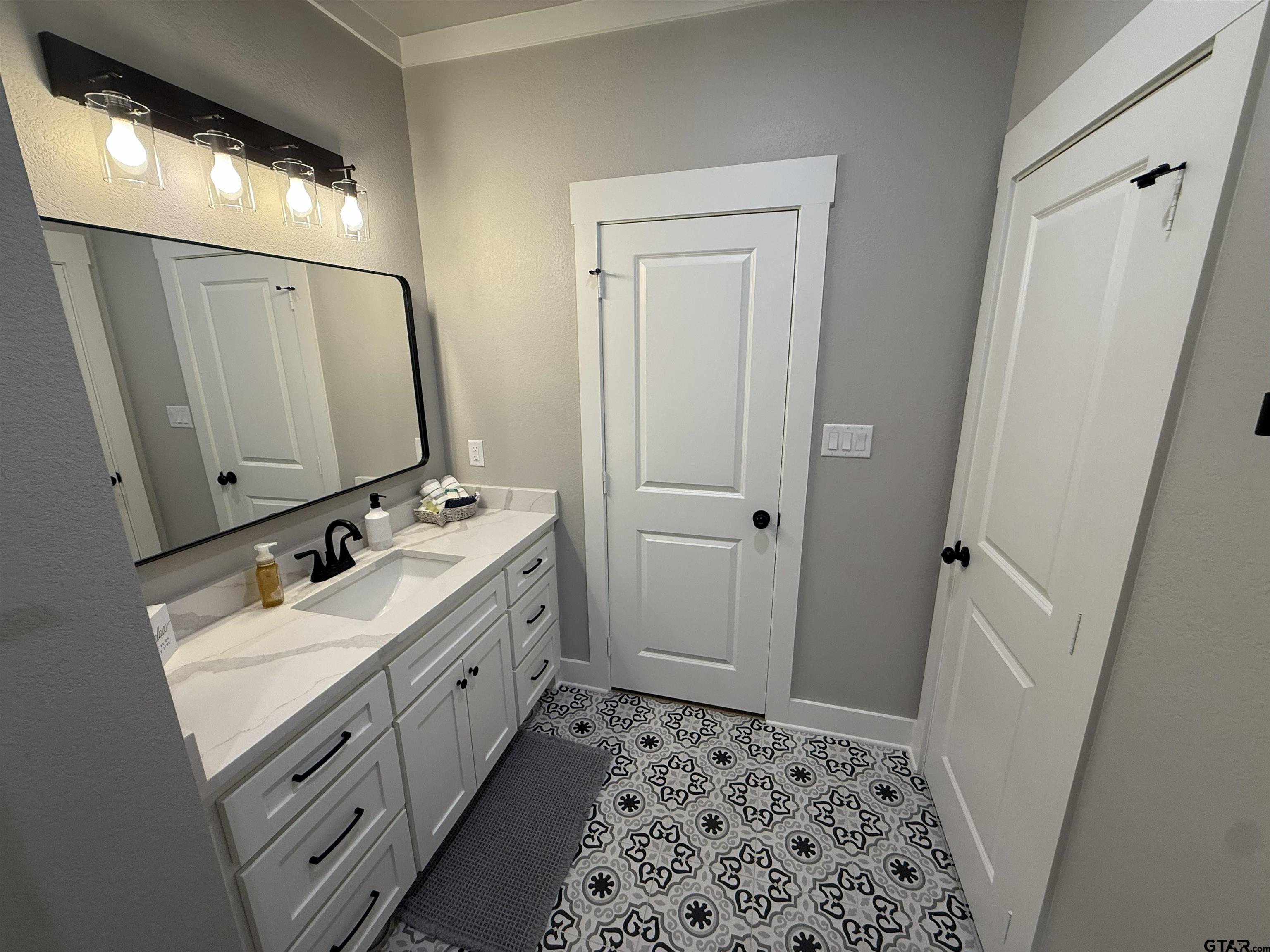 16093 County Road 189 West Flint, TX 75762 - Photo 36 of 46 a bathroom with a sink a toilet and a mirror