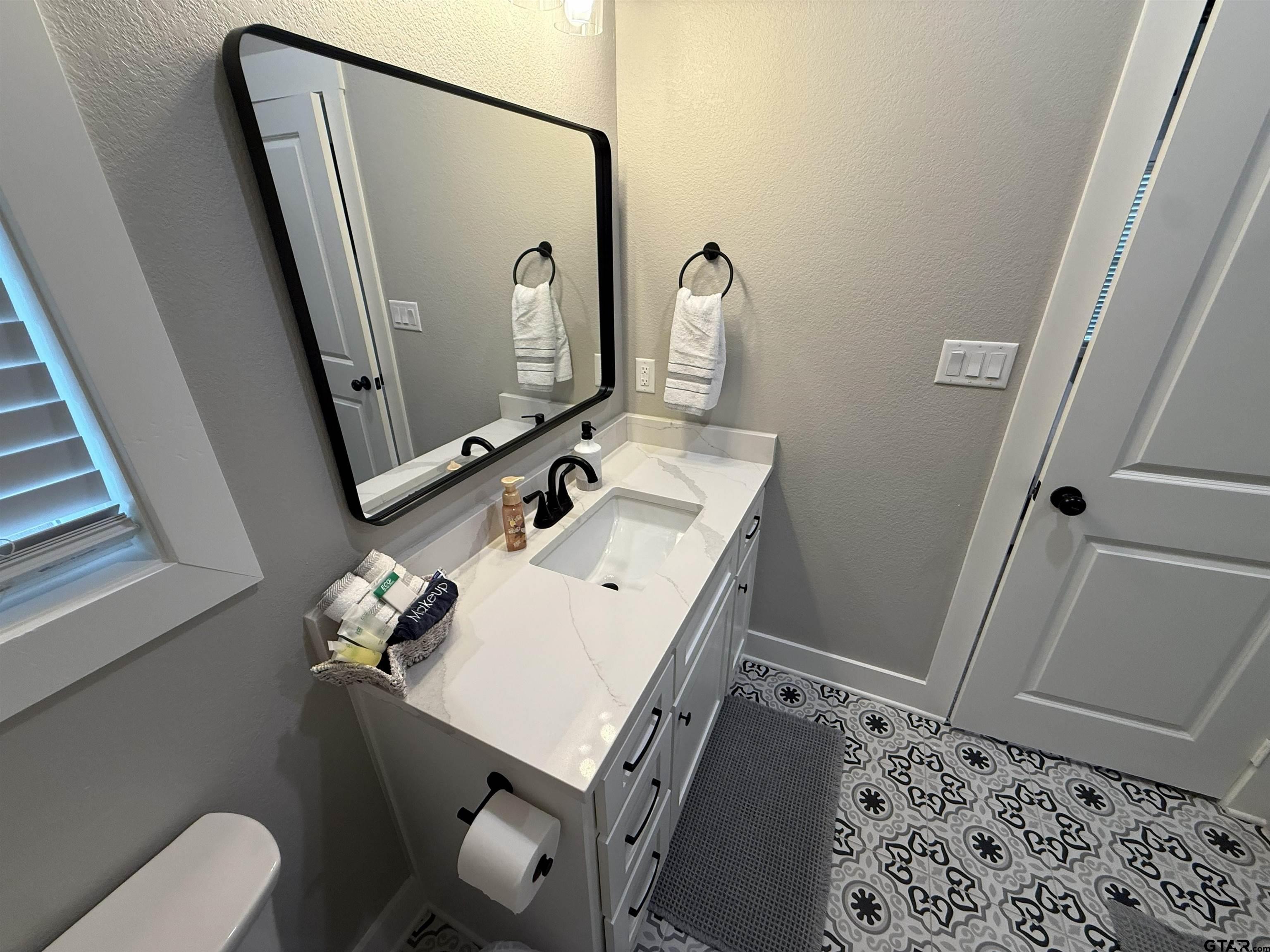 16093 County Road 189 West Flint, TX 75762 - Photo 43 of 46 a bathroom with a sink mirror and toilet