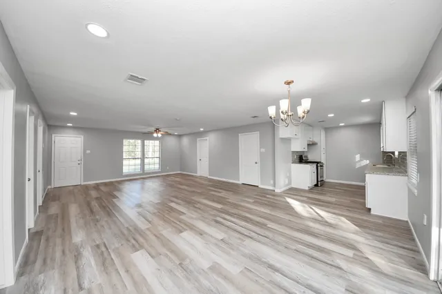 a kitchen with a stove and white cabinets
