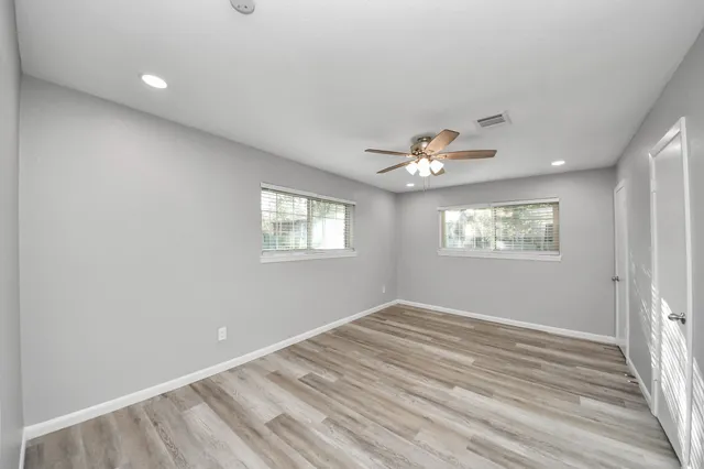 a view of empty room with wooden floor