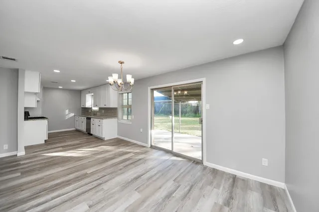 a view of a kitchen with wooden floor and a kitchen