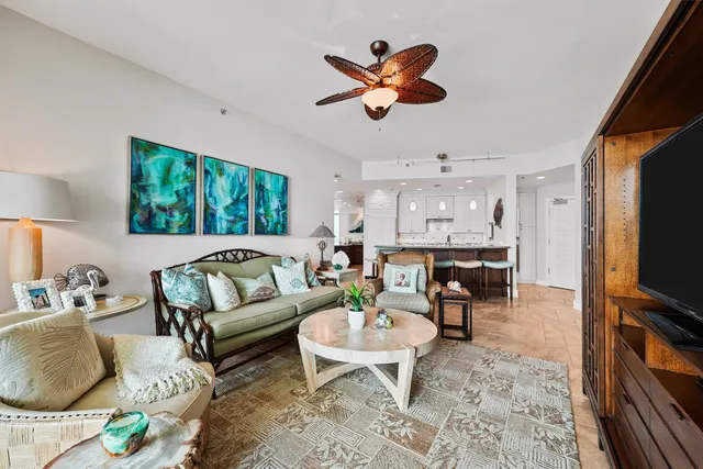a living room with furniture a window and a flat screen tv
