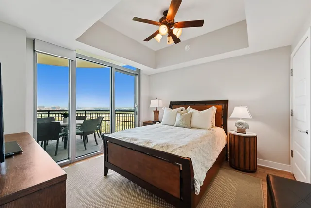 a large bedroom with a bed and large window