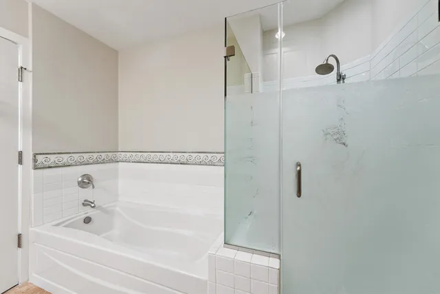 a bathroom with a bathtub and a shower