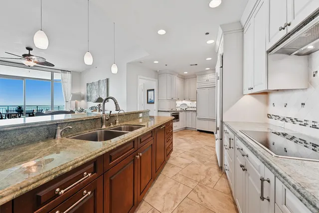 a kitchen with a sink stove and cabinets