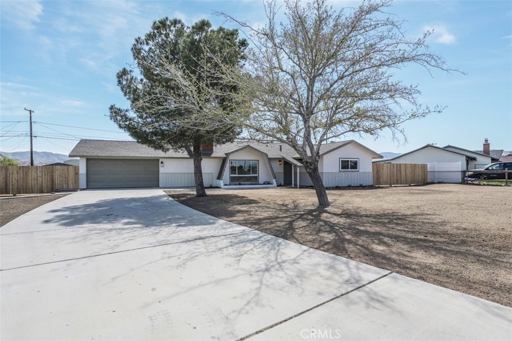 12407 Tonikan Road Apple Valley, CA 92308 - Photo 1 of 1 a view of house with backyard and tree