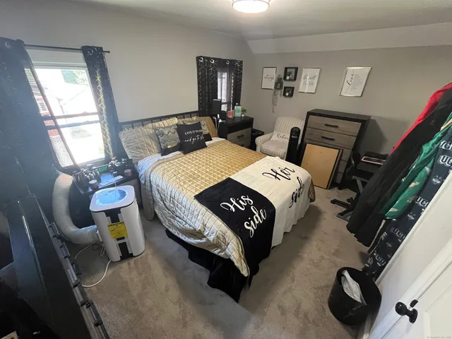 a bedroom with bed and window