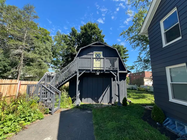 a view of a backyard with large trees