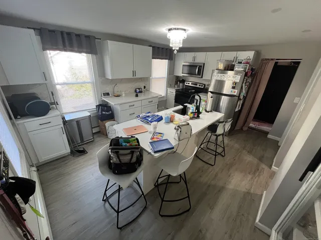 a dining room with furniture and wooden floor