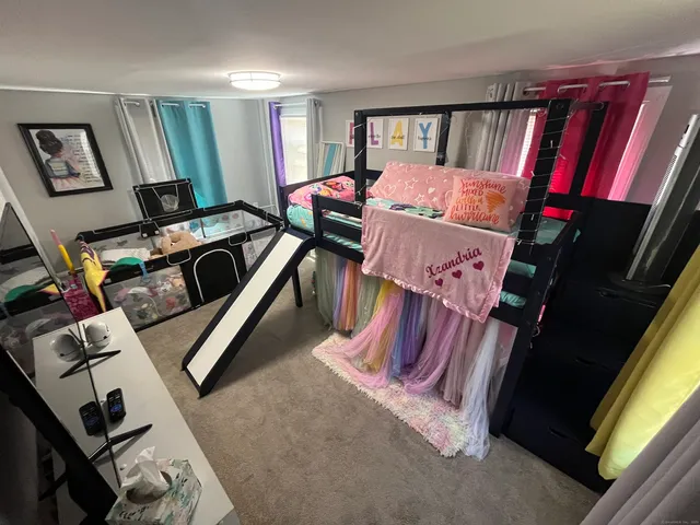 a bedroom with furniture and a air conditioner vent